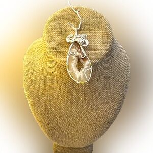 Wire wrapped clear quartz geode pendant.